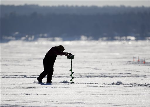 In this Saturday, Jan. 31, 2015 photo, a man augers a hole for ice fishing on Great Sacandaga Lake on Saturday, Jan. 31, 2015, in Mayfield, N.Y. The all-day Sacandaga competition offered cash prizes totaling $1,649 each hour for the biggest catches plus big-ticket prizes like a snowmobile. (AP Photo/Mike Groll)