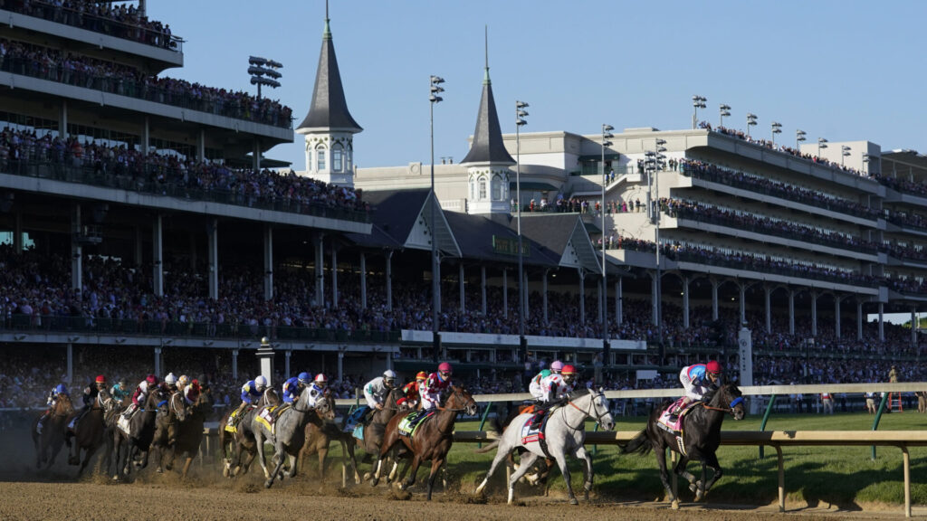 Medina Spirit, right, with John Velazquez aboard, leads the field around the first turn on the way to winning the 147th running of the Kentucky Derby at Churchill Downs, Saturday, May 1, 2021, in Louisville, Ky. (AP Photo/Michael Conroy)