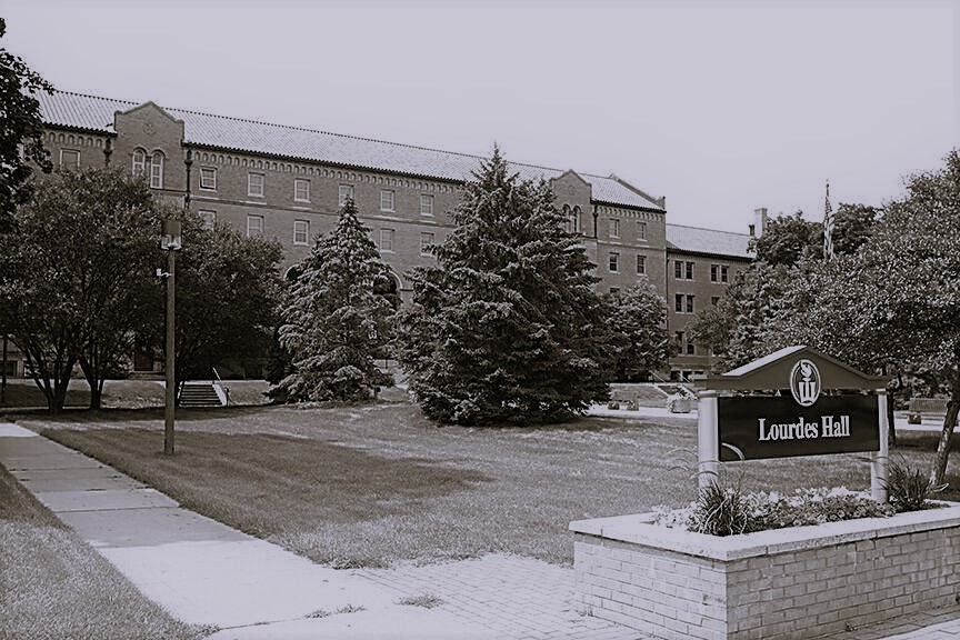Black and white photo of a closed down haunted Lourdes Hall as Winona State University tries to sell the property. 
