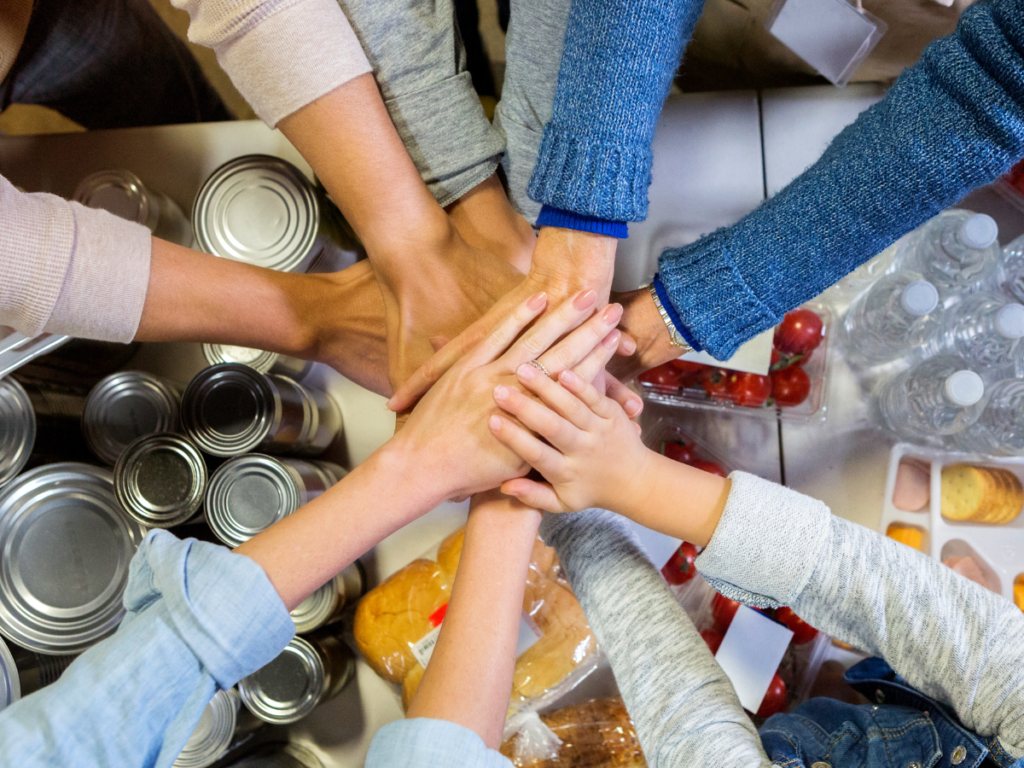 Volunteers place their hands in the middle as a team since they all took up the volunteer opportunities in the La Crosse and surrounding River City area.