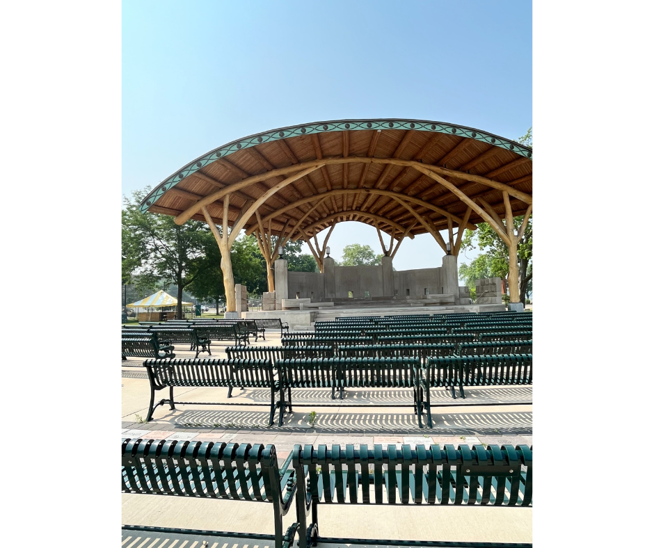 Riverside Park bandshell with green benches facing the bandshell