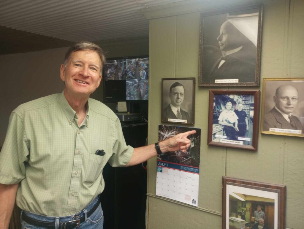 Bill Kroner displays photos of past family members who ran the hardware store.