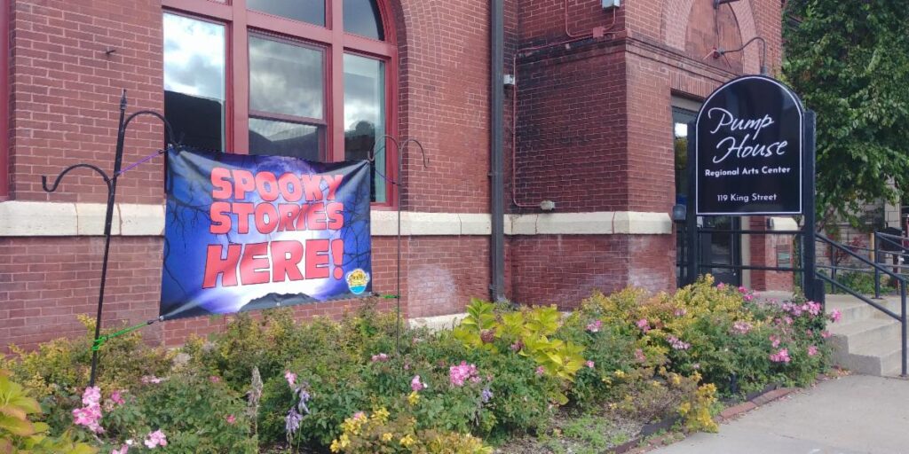 Banner reading “Spooky Stories Here!” outside the Pump House Regional Arts Center in La Crosse, Wisconsin.