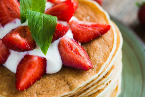 Stack of pancakes with berries to go with Hollandberry Pannekoeken La Crosse location