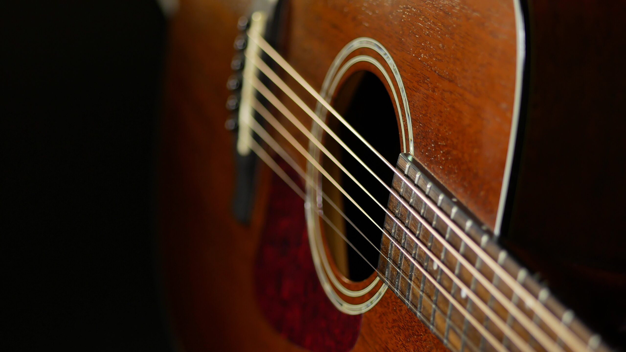 close-up of an acoustic guitar representing the intimate folk sound audiences can expect at the Johnsmith Pump House concert at the Pump House Regional Arts Center.