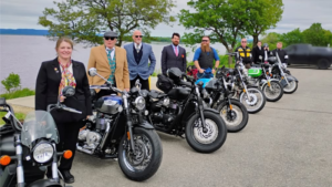 Distinguished Gentlemen Riders lined up next to motorcycles at Riverside Park, La Crosse, WI.