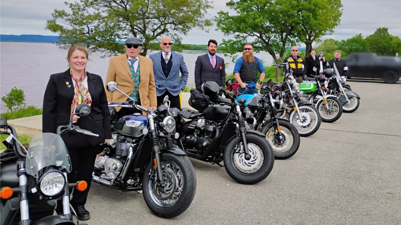 Distinguished Gentlemen Riders lined up next to motorcycles at Riverside Park, La Crosse, WI.